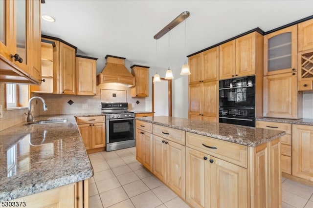 kitchen featuring sink, a kitchen island, custom exhaust hood, black double oven, and stainless steel range