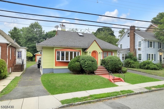 bungalow-style home with a front yard