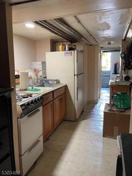 kitchen featuring sink and white appliances