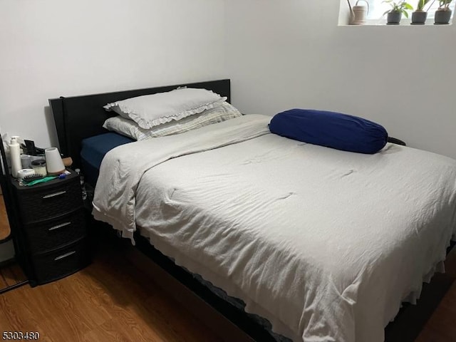 bedroom with hardwood / wood-style flooring