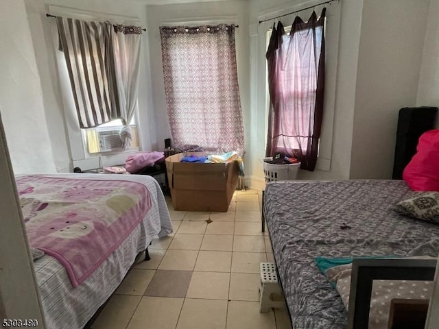 bedroom featuring light tile patterned flooring and cooling unit