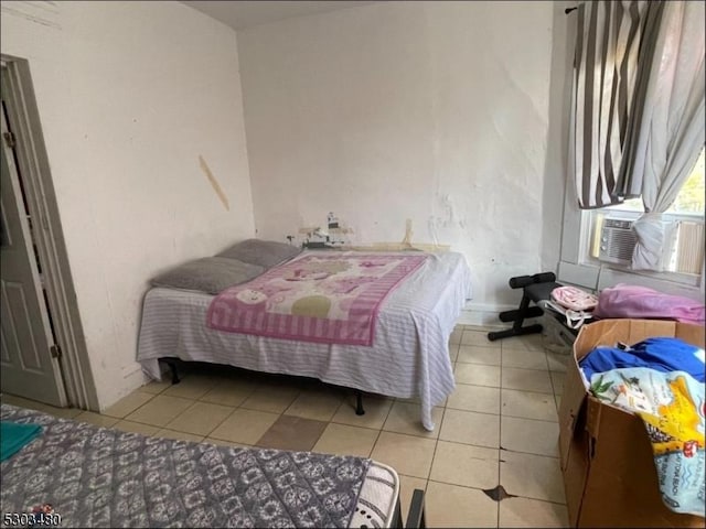 bedroom with light tile patterned floors