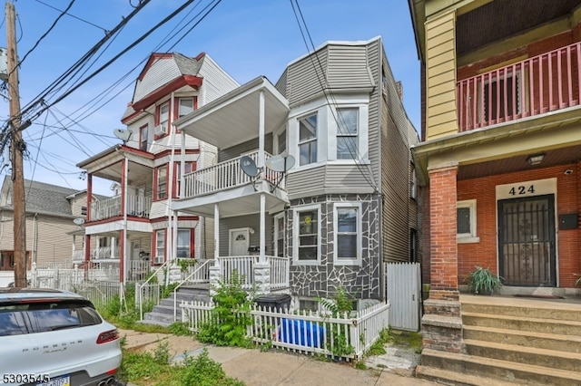 view of front of property with a balcony and a porch