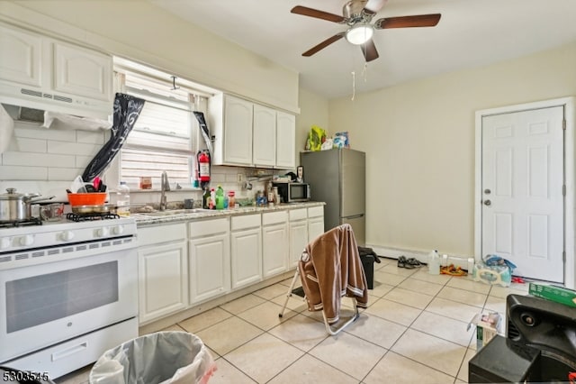 kitchen with white cabinetry, tasteful backsplash, ceiling fan, sink, and appliances with stainless steel finishes