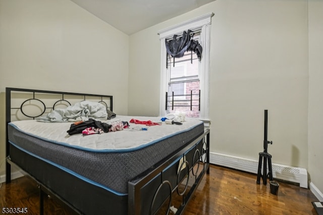 bedroom featuring dark wood-type flooring and lofted ceiling