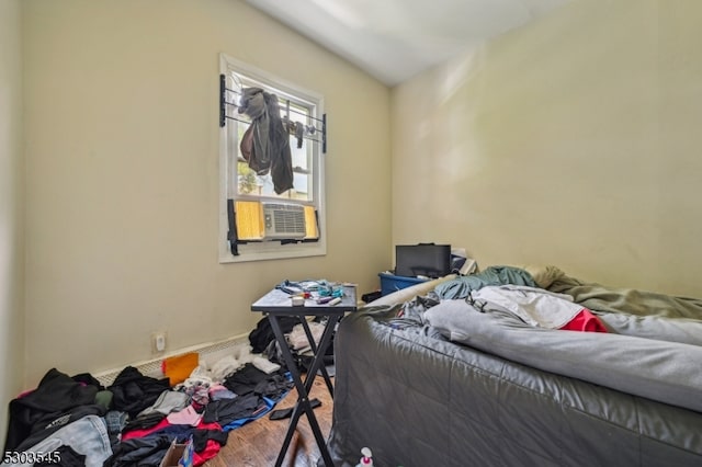 bedroom with cooling unit and hardwood / wood-style floors