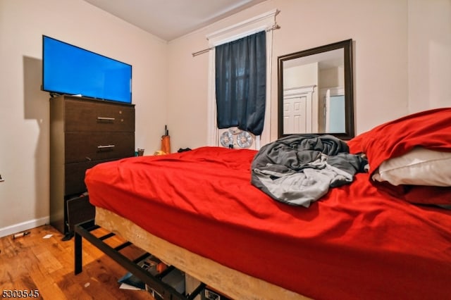 bedroom with hardwood / wood-style flooring