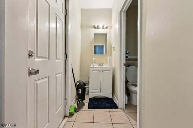 bathroom with vanity, toilet, and tile patterned flooring