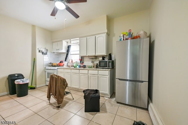 kitchen with white cabinetry, ceiling fan, appliances with stainless steel finishes, light tile patterned floors, and backsplash