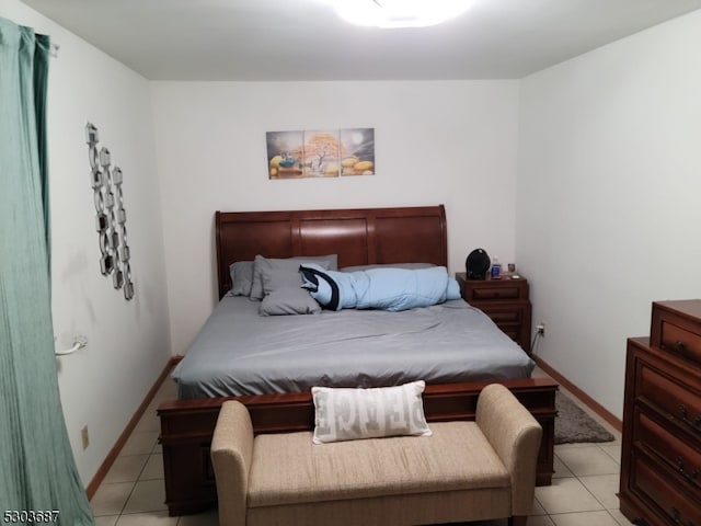 bedroom with light tile patterned floors