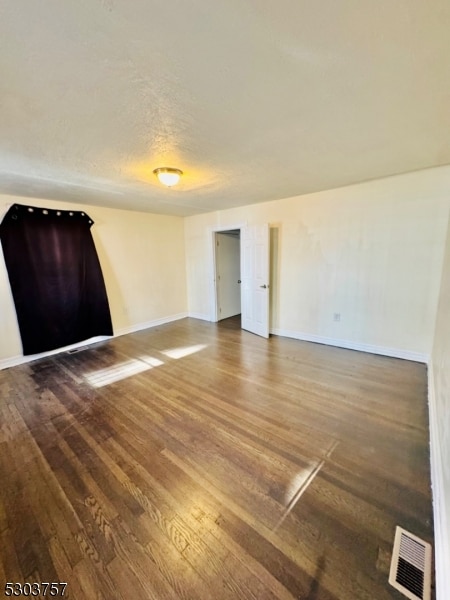 spare room featuring wood-type flooring