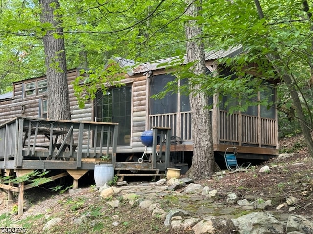 rear view of house with a deck with water view