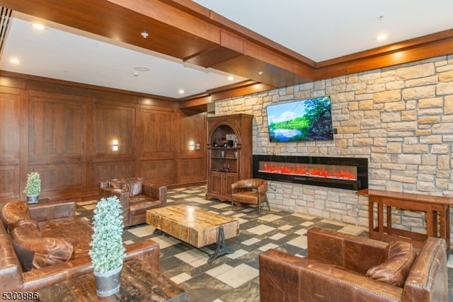 tiled living room featuring beam ceiling and a stone fireplace