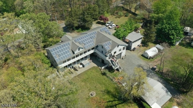 view of front of house with a balcony and a front lawn