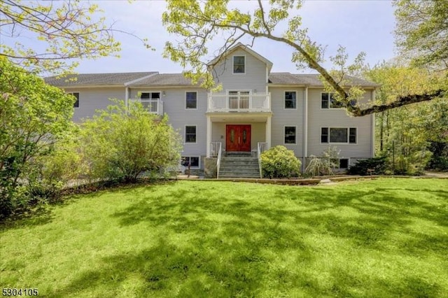 back of property with a garage and a lawn