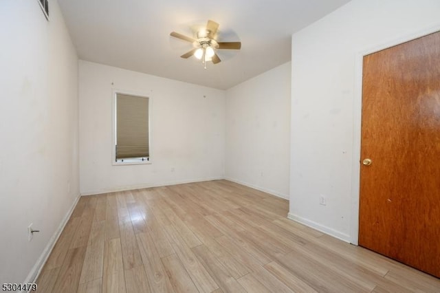 spare room with ceiling fan and light wood-type flooring