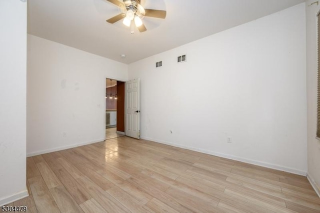 spare room with ceiling fan and light wood-type flooring