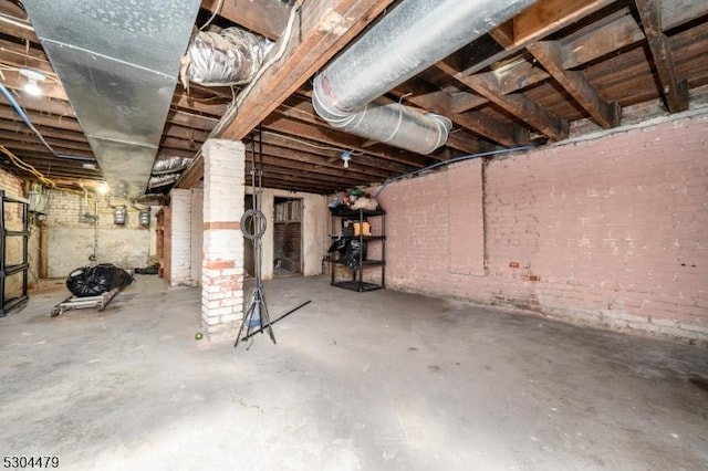 basement featuring brick wall