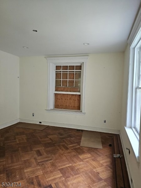 unfurnished room featuring parquet floors