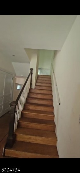 staircase with hardwood / wood-style floors