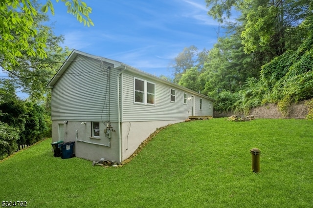 view of property exterior featuring a lawn