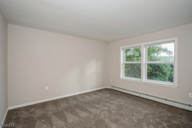 carpeted spare room featuring a baseboard radiator