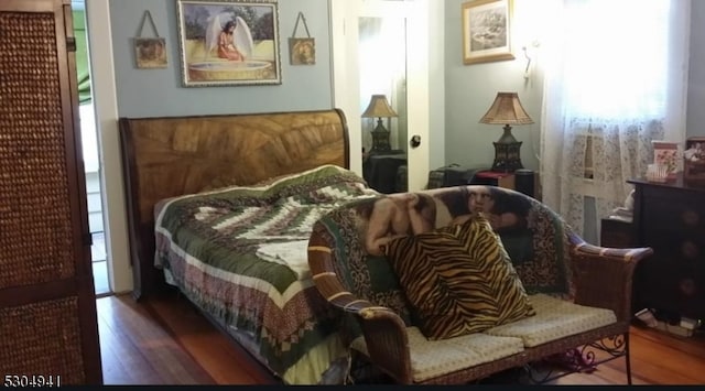 bedroom featuring dark hardwood / wood-style flooring