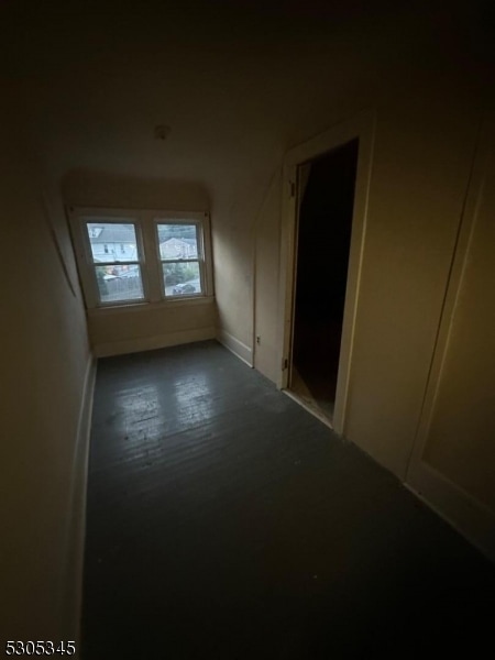 corridor with hardwood / wood-style flooring