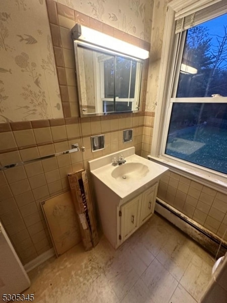 bathroom with backsplash, tile walls, vanity, and tile patterned floors