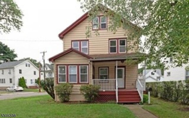 view of front of home with a front lawn and a porch