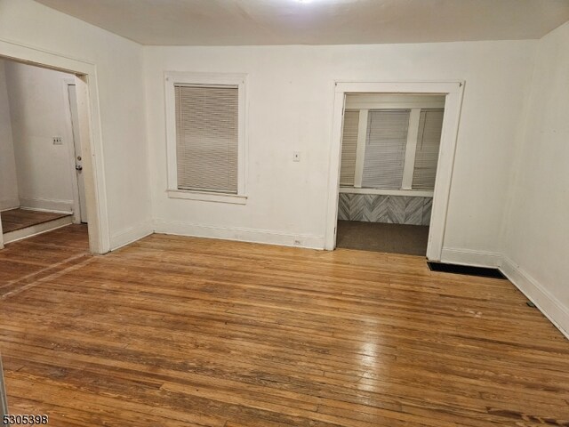 unfurnished room featuring hardwood / wood-style floors