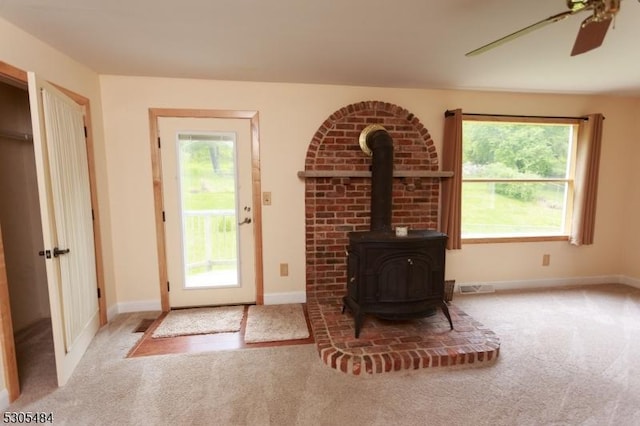 47 Sarepta Rd, White Twp, NJ 07823 - living area featuring carpet flooring, a wood stove, plenty of natural light, and ceiling fan
