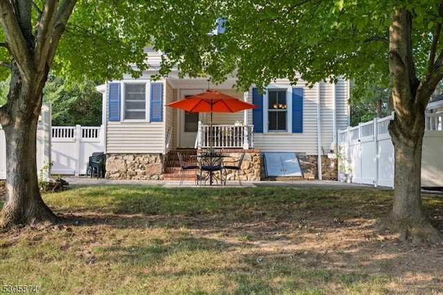 rear view of property with a lawn