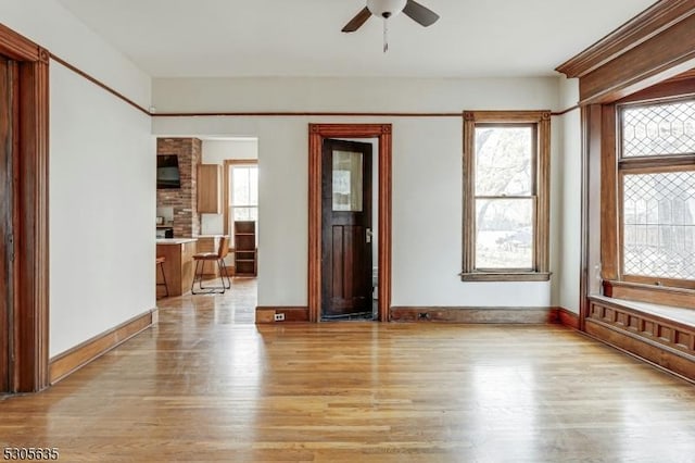 empty room featuring ceiling fan and light hardwood / wood-style floors