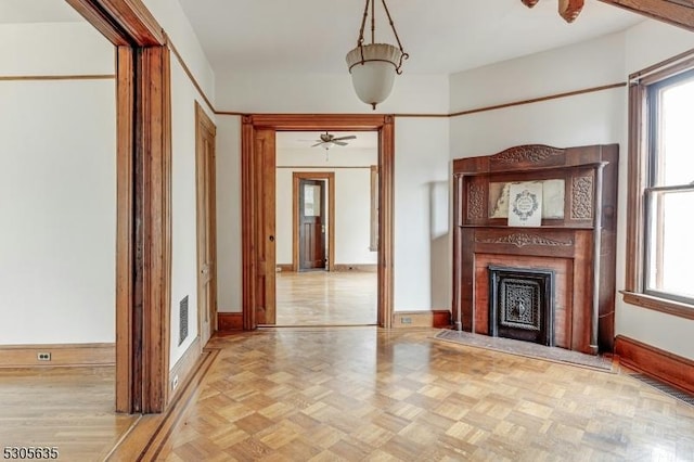 unfurnished living room featuring ceiling fan and light parquet flooring