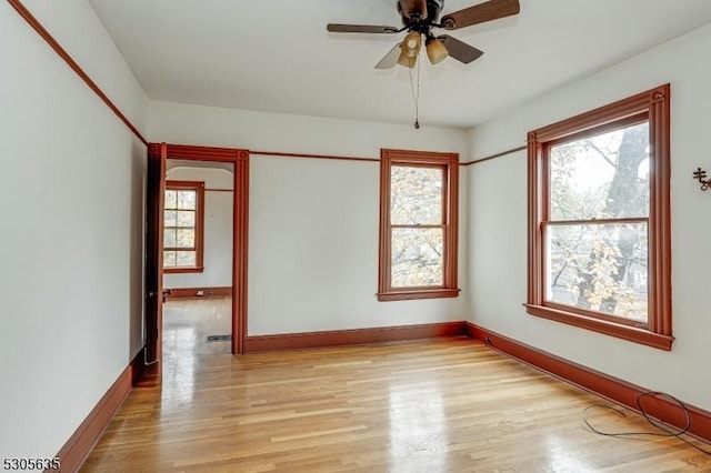 unfurnished room featuring light hardwood / wood-style floors and ceiling fan