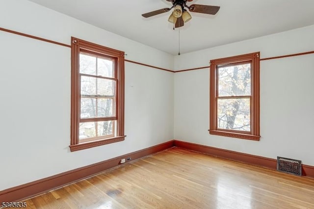 spare room featuring ceiling fan and light wood-type flooring