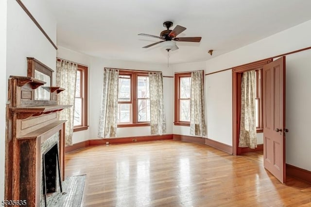 unfurnished living room with light hardwood / wood-style floors and ceiling fan