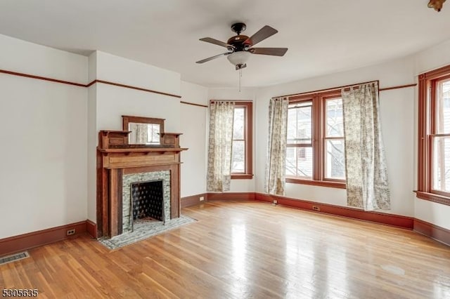 unfurnished living room featuring ceiling fan and wood-type flooring