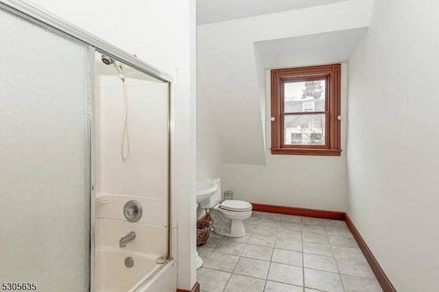 bathroom with tile patterned flooring, toilet, and bath / shower combo with glass door