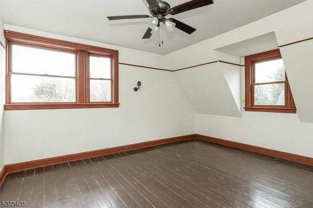 additional living space featuring dark hardwood / wood-style floors, ceiling fan, and lofted ceiling