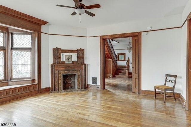 living room with ceiling fan and light wood-type flooring