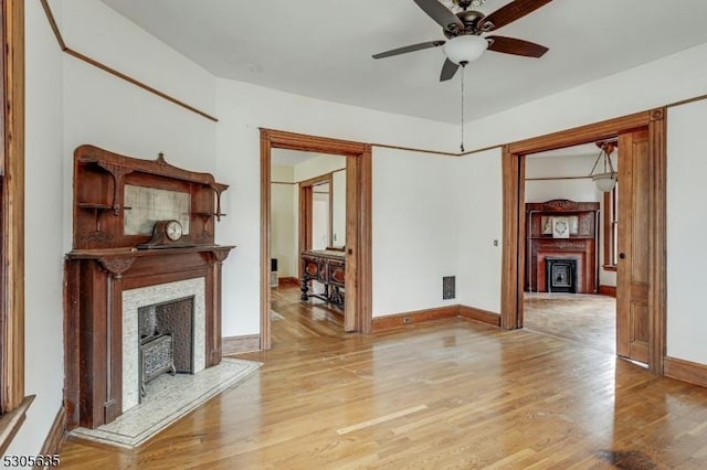 unfurnished living room with light hardwood / wood-style floors and ceiling fan