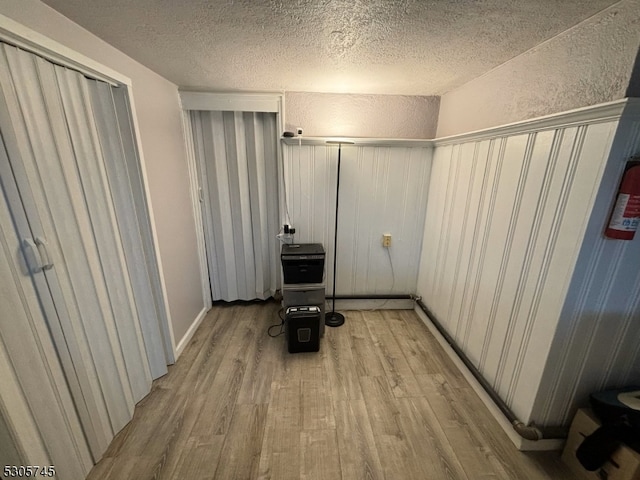 interior space with hardwood / wood-style flooring and a textured ceiling