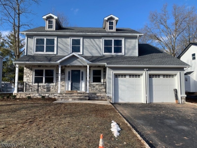 view of front of home featuring covered porch and a garage