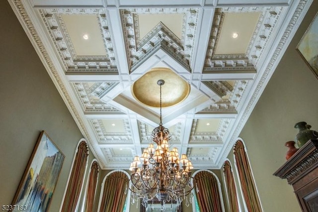 interior details featuring coffered ceiling and a notable chandelier