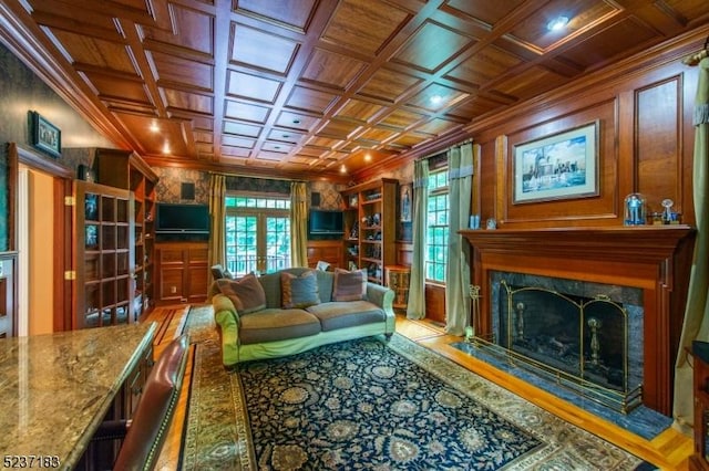 living room featuring french doors, coffered ceiling, and wooden ceiling