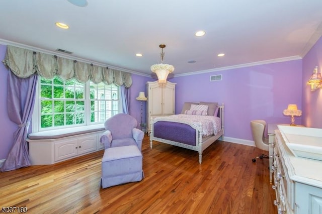 bedroom featuring ornamental molding and light hardwood / wood-style floors