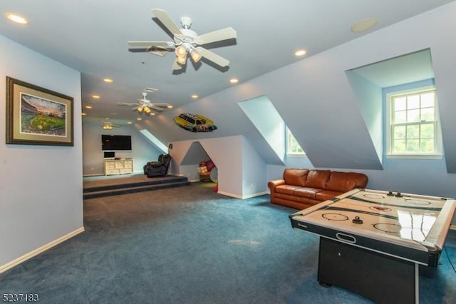 rec room with lofted ceiling, a healthy amount of sunlight, and dark colored carpet