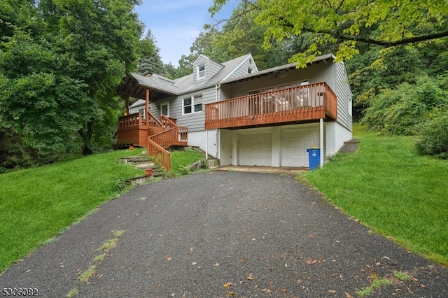 view of front of home with a front lawn, a deck, and a garage